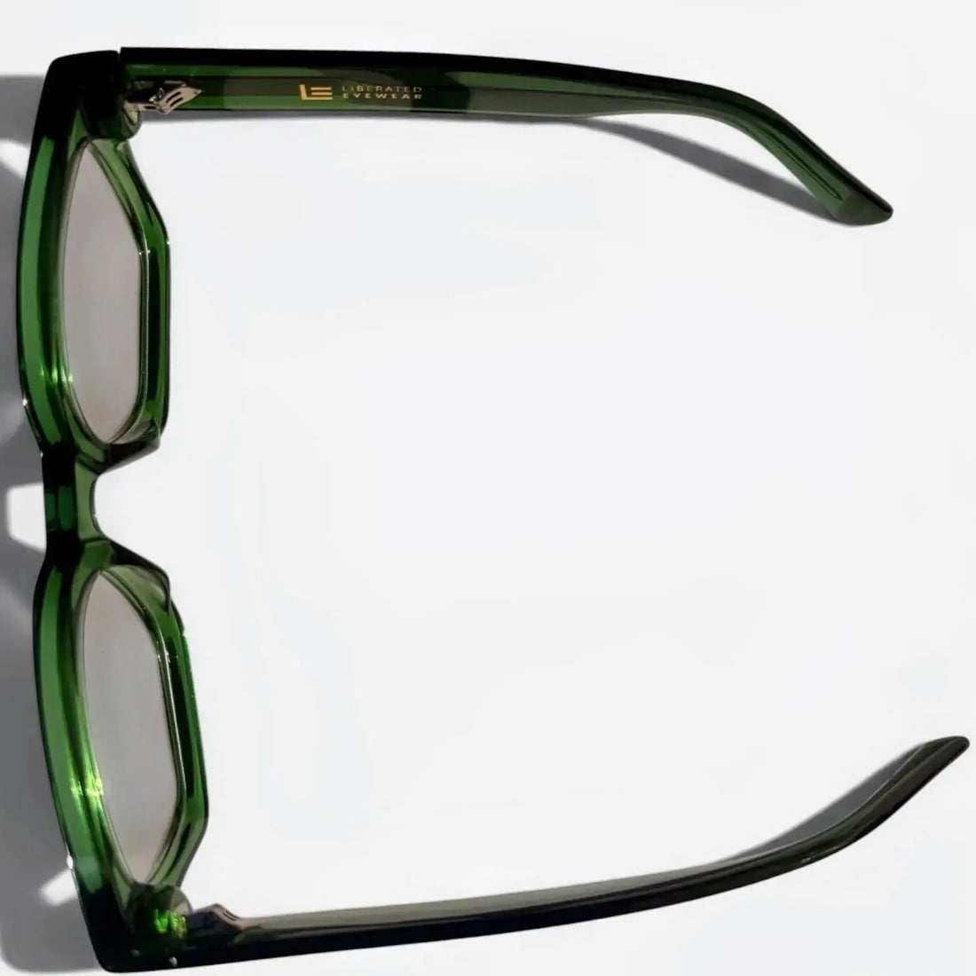 Liberated Eyewear, Inc. Jade rectangular glasses in translucent green handcrafted acetate with a modern profile