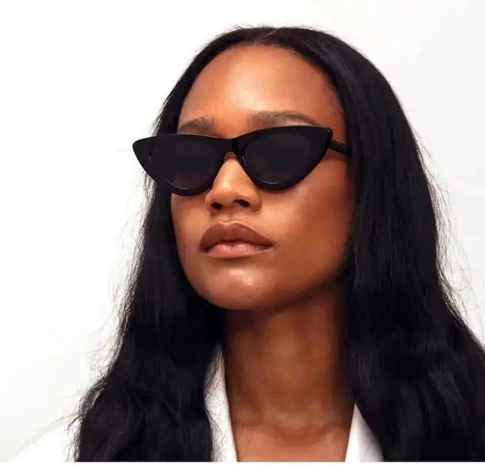 A head shot of a woman wearing black  Italian acetate eco friendly cat eye sunglasses with a glossy finish and uv protection polarized lens.